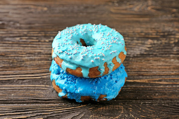 Wall Mural - Tasty donuts on wooden table