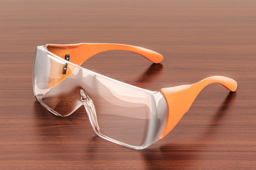 Wall Mural - Safety glasses on the wooden table. 3D rendering