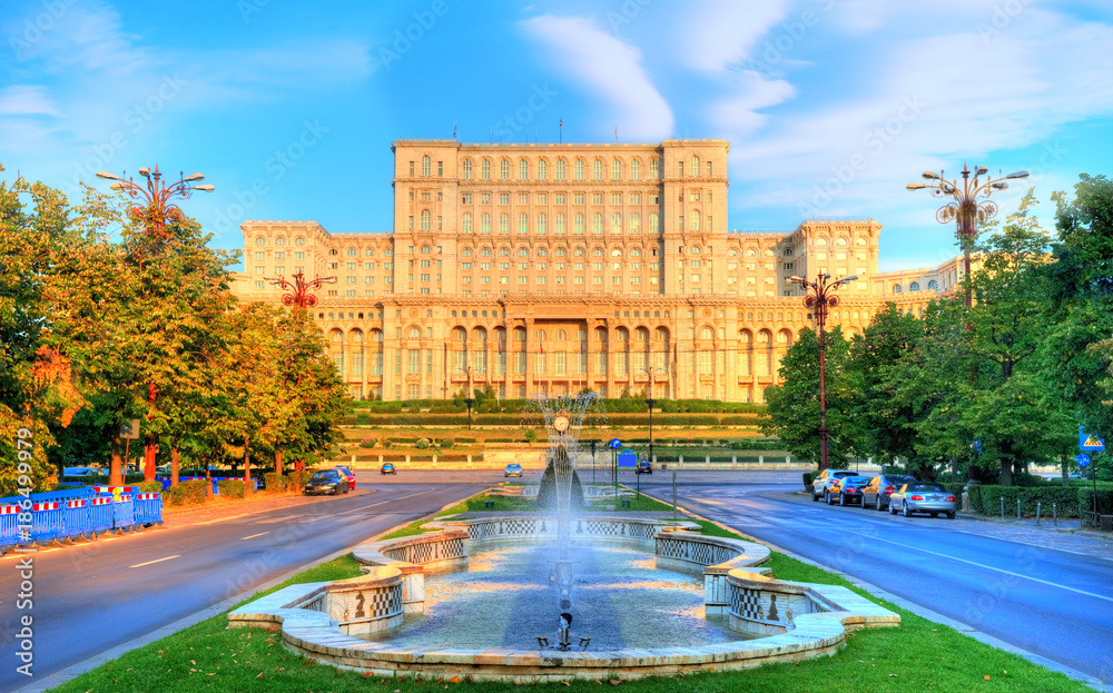Obraz na płótnie One of the famous and biggest building in the world Palace of Parliament illuminated by sunrise in Bucharest, capital of Romania in Eastern Europe w salonie