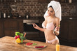 © LIGHTFIELD STUDIOS - sexy young woman in lingerie and towel smiling at camera while cooking at home
