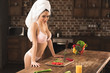 © LIGHTFIELD STUDIOS - sexy young woman in lingerie looking at camera while cooking at home