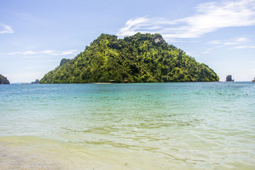 Mountain and sea view with three boats of tourist in front of the mountain and clear sky in Krabi, Thailand