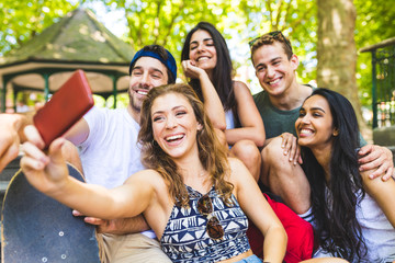 Wall Mural - Happy multiethnic group of friends taking a selfie