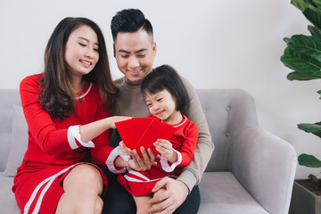 Happy Vietnamese family celebrate Lunar new year at home.