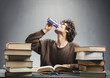 © Photocreo Bednarek - Young man studying and drinking energy drink.