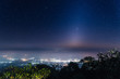 The beautiful zodiacal light, stars and city light on the peak of the mountains. Doi luang chiang dao, Chiang dao national park, Chiang mai, Thailand.