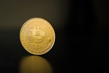 Single Bitcoin Coin Close Up On The Surface