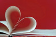 © izzzy71 - Heart shape made of book pages on red background with copy space. Creative love background concept.