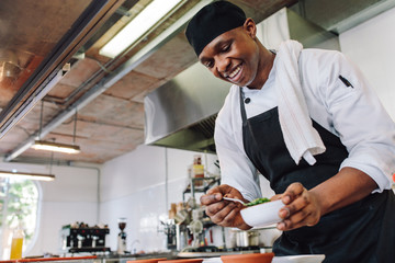 Wall Mural - Gourmet chef cooking in a commercial kitchen