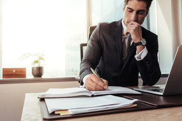 Wall Mural - Male entrepreneur working at his desk