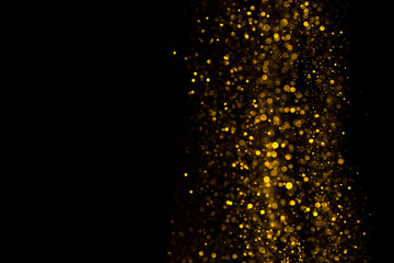 Wall Mural - Falling glitter dust bright bokeh border on black background with copy space