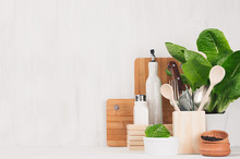 Natural Beige And Brown Wooden Kitchenware And Green Plant On Light White Wood Background, Copy Space.
