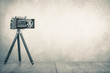 Retro old outdated manual film camera from USSR circa 1950s on wooden table. Vintage style sepia photo