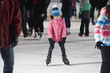 © Petr Bonek - Child young girl ice skating at the ice rink outdoors. Child learning to skate on public rink.  Ice skaters using a temporary rink during the Christmas and New Year holiday period