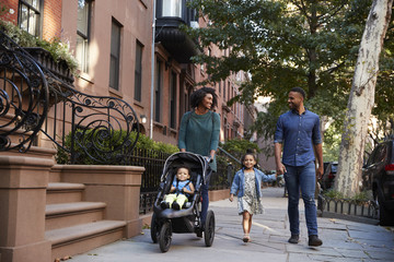 Family taking a walk down the street