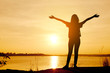 © ittipol - Young woman relaxing in summer sunset sky outdoor