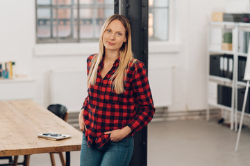 Wall Mural - Relaxed casual businesswoman in a modern office