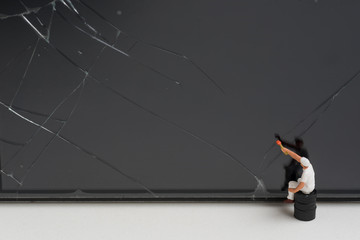 Wall Mural - miniature people try to repair a cracked smart phone screen