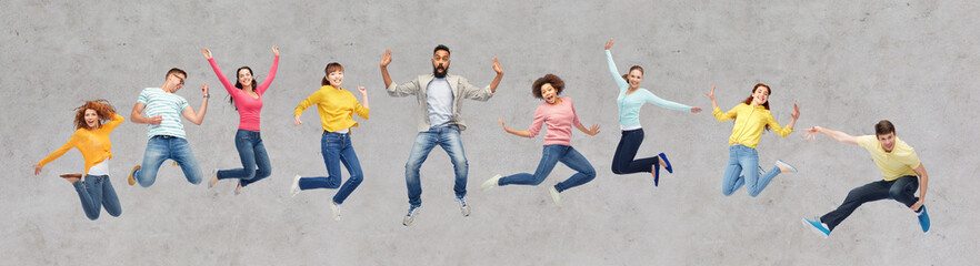 Wall Mural - happy people or friends jumping in air over gray