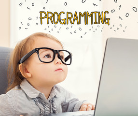 programming text with toddler girl using her laptop