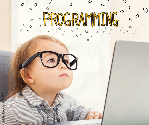 Programming text with toddler girl using her laptop Wallpaper Mural