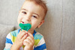 © oksanazahray - Toddler chewing a green nipple
