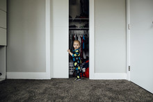 Portrait Of Baby Boy Standing At Closet