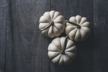 Overhead View Of White Pumpkins On Wooden Table