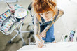 © Cavan Images - High angle view of artist drawing sketch on canvas in studio