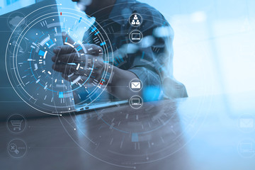 Poster - businessman hand working with modern laptop computer in modern office with virtual icon diagram