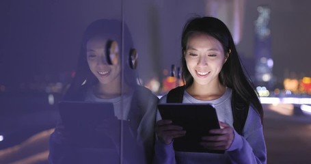 Poster - Woman reading on tablet computer at night