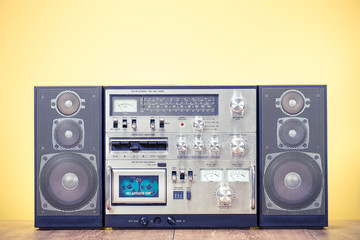 Wall Mural - retro outdated stereo boombox radio cassette recorder circa 1980s front yellow background. vintage o
