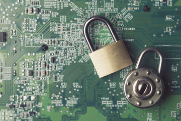 Wall Mural - Padlock on a computer electronic circuit board. Technology security concept