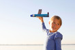 © Connect Images - Young girl, outdoors, playing with toy aeroplane