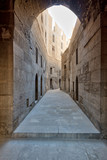 Fototapeta Na drzwi - Narrow passage with old grunge stone walls leading to Sultan Hasan Mosque, Cairo, Egypt