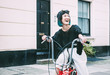 © Connect Images - Young stylish woman cycling retro bicycle on street