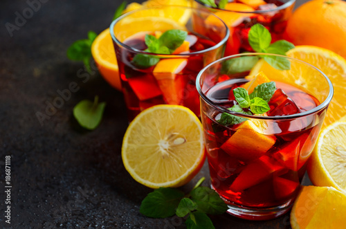 Cuadros en Lienzo Spanish sangria cocktail and ingredients on dark concrete or stone background, selective focus, copy space