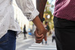 © Monkey Business - Close Up Of Couple Holding Hands On Urban Street