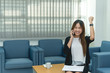 © reewungjunerr - Beautiful asian businesswoman working at the office  in the evening,Thailand worker happy after looking laptop,Success from work