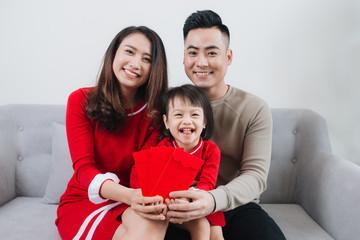 Wall Mural - Happy Vietnamese family celebrate Lunar new year at home.