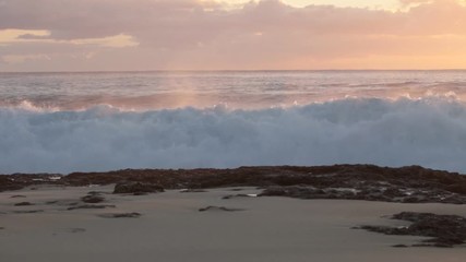 Wall Mural - shorebreak ocean waves near rocky coast and cliffs, rough sea water at sunset time