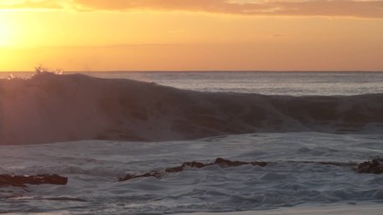 Wall Mural - shorebreak ocean waves near rocky coast and cliffs, rough sea water at sunset time