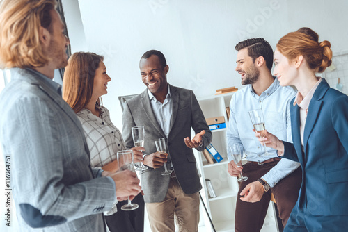Fotografie, Obraz business team celebrating with beverage in glasses at office space