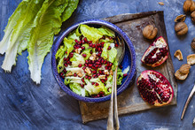 Bowl Of Romaine Lettuce With Walnuts, Pomegranate Dressing And Seed