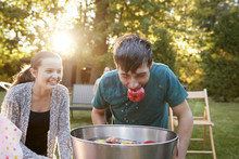 Teenage Boy, Apple In Mouth, Apple Bobbing At Garden Party