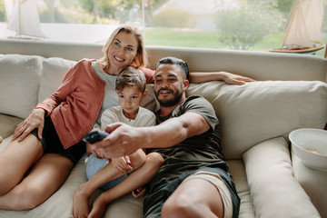 Relaxed family watching tv together