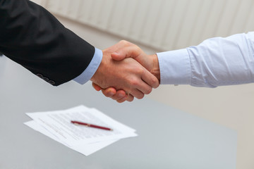 handshake after signing the contract. Two businessman shaking hands