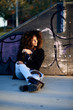 Beautiful girl with afro against graffiti wall.