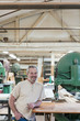 © Jetta Productions/Stocksy - Portrait of smiling craftsman in cabinet shop