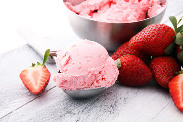 Wall Mural - Delicious strawberry ice cream scoop with fresh strawberries on wooden background